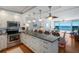 Bright kitchen featuring a large island with seating, stainless steel appliances, and ocean views at 5300 Gulf Dr # 204, Holmes Beach, FL 34217