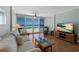Comfortable living room with ocean views, couch, coffee table, and a flatscreen TV at 5300 Gulf Dr # 204, Holmes Beach, FL 34217