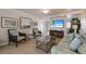 Well-appointed living room includes stylish furnishings, artwork and a flat screen television at 5300 Gulf Dr # 204, Holmes Beach, FL 34217