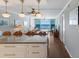 Open-concept living area with bright, modern lighting fixtures and ocean views at 5300 Gulf Dr # 204, Holmes Beach, FL 34217