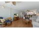 Bright living room with beach-themed decor, ceiling fan and a seamless flow into the dining area and kitchen at 5300 Gulf Dr # 204, Holmes Beach, FL 34217