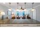 Bright living space with ocean view through wide glass windows, island seating, and decorative hanging lights at 5300 Gulf Dr # 204, Holmes Beach, FL 34217