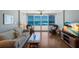 Living space features a sofa, coffee table, mounted flatscreen TV, and an ocean view at 5300 Gulf Dr # 204, Holmes Beach, FL 34217