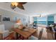 Inviting living room with hardwood floors, comfortable seating, and stunning ocean views from large windows at 5300 Gulf Dr # 204, Holmes Beach, FL 34217