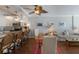 Open concept living room with dining area, island seating, natural light and access to a modern kitchen at 5300 Gulf Dr # 204, Holmes Beach, FL 34217