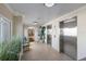 An airy lobby with tile flooring, two elevators, chairs, and tropical plants at 5300 Gulf Dr # 204, Holmes Beach, FL 34217