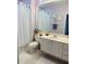 Bathroom featuring a single vanity, white shaker cabinets, and stylish mirror that complements the soft lavender walls at 5360 Davini St, Sarasota, FL 34238