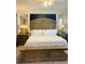 Luxurious bedroom with a grand headboard, bright lighting, and mirrored accents offering space and style at 5360 Davini St, Sarasota, FL 34238