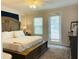 Tranquil bedroom features a large bed, neutral tones, a ceiling fan and access to the exterior patio at 5360 Davini St, Sarasota, FL 34238