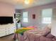 Inviting bedroom with calming lavender walls, plush carpet, a ceiling fan and bright, shuttered windows at 5360 Davini St, Sarasota, FL 34238