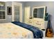 Comfortable bedroom with a large dresser, guitar, and bright natural light, creating a cozy and inviting space at 5360 Davini St, Sarasota, FL 34238