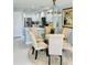 Bright dining area with modern light fixture adjacent to the open kitchen at 5360 Davini St, Sarasota, FL 34238
