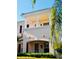 Charming two-story townhome featuring a balcony and lush landscaping at 5360 Davini St, Sarasota, FL 34238