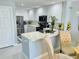 Modern kitchen with white cabinets, stainless steel appliances, and quartz countertops at 5360 Davini St, Sarasota, FL 34238