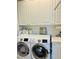 Convenient laundry room with Samsung washer and dryer and white shaker cabinets, perfect for everyday laundry tasks at 5360 Davini St, Sarasota, FL 34238
