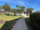 Scenic community walkway with tropical landscaping leading to resort-style amenities at 5507 Ashton Way # 5507, Sarasota, FL 34231