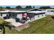 The backyard features patio furniture, and an umbrella for shade at 5727 25Th W St, Bradenton, FL 34207
