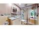 A well-lit bathroom features stone accents, a glass shower, and modern fixtures at 5727 25Th W St, Bradenton, FL 34207