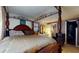 Bedroom featuring a beautiful four-poster bed with stylish linens, complementing the room's serene atmosphere at 5727 25Th W St, Bradenton, FL 34207