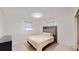 Cozy bedroom featuring a queen bed with serene natural lighting, and neutral tones creates a relaxing environment at 5727 25Th W St, Bradenton, FL 34207