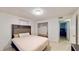The bedroom showcases a bed, closet and view into another room at 5727 25Th W St, Bradenton, FL 34207