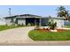 Charming single-story home with a well-manicured lawn and a curved driveway at 5727 25Th W St, Bradenton, FL 34207