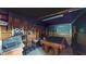 The garage is currently a rec room, with a pool table, stools and chairs at 5727 25Th W St, Bradenton, FL 34207