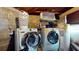 This utility room features a washer, dryer, and shelving for storage solutions at 5727 25Th W St, Bradenton, FL 34207