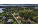 An aerial view showcases this property's location within a lush neighborhood near a beautiful waterfront area at 60 Liles St, Terra Ceia, FL 34250