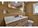 This bathroom has a light wood vanity, white counter, and black hardware at 60 Liles St, Terra Ceia, FL 34250