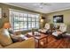 Cozy living room with large windows, comfortable seating, hardwood floors, and neutral decor offering a relaxing ambiance at 60 Liles St, Terra Ceia, FL 34250