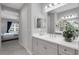 Modern bathroom vanity featuring gray cabinets, a bright mirror, and stylish decor adjacent to the bedroom at 6255 Cassia St, Bradenton, FL 34203