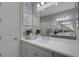 Bright bathroom with a large mirror, dual sinks, and modern lighting fixtures at 6255 Cassia St, Bradenton, FL 34203