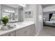 Stylish bathroom features a vanity with a white countertop and a well-lit mirror, adjacent to the bedroom at 6255 Cassia St, Bradenton, FL 34203