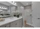 Elegant bathroom with dual vanities, a glass-enclosed shower, and stylish fixtures at 6255 Cassia St, Bradenton, FL 34203