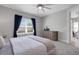 Light-filled bedroom featuring a large window, plush carpet, and a dresser for storage at 6255 Cassia St, Bradenton, FL 34203