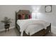 Cozy bedroom with a stylish bed, decorative pillows, a leafy plant, and a complementary floor lamp at 6255 Cassia St, Bradenton, FL 34203