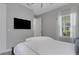 Serene bedroom with a ceiling fan, television, sheer curtains, and a comfortable queen-sized bed at 6255 Cassia St, Bradenton, FL 34203