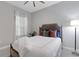Charming bedroom with a queen bed, colorful pillows, sheer curtains and a sleek floor lamp at 6255 Cassia St, Bradenton, FL 34203
