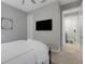 Spacious bedroom features a TV, an ensuite bathroom, and soft carpeting at 6255 Cassia St, Bradenton, FL 34203