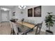 Dining room features a table set for six beneath a modern chandelier at 6255 Cassia St, Bradenton, FL 34203