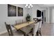 Dining room features a table set for six beneath a modern chandelier at 6255 Cassia St, Bradenton, FL 34203