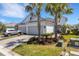 Exterior of home with a two car garage, complemented by well-maintained landscaping and mature palms at 6255 Cassia St, Bradenton, FL 34203