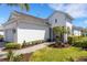 Side view of home featuring manicured landscaping, covered entryway and walkway to the front door at 6255 Cassia St, Bradenton, FL 34203