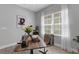 Inviting home office features a wood desk, large windows with sheer curtains, and stylish decor at 6255 Cassia St, Bradenton, FL 34203