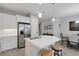 Bright kitchen features white cabinetry, stainless steel appliances, and a spacious island with seating for two at 6255 Cassia St, Bradenton, FL 34203