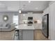 Bright kitchen featuring a large island with a breakfast bar, stainless steel appliances and ample cabinet space at 6255 Cassia St, Bradenton, FL 34203