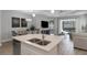Open concept eat-in kitchen features an island, breakfast nook, and a view into the living area at 6255 Cassia St, Bradenton, FL 34203