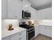 Bright kitchen features white cabinetry, stainless steel appliances and stone countertops at 6255 Cassia St, Bradenton, FL 34203