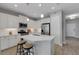 Bright kitchen features white cabinetry, stainless steel appliances, and a spacious island with seating for two at 6255 Cassia St, Bradenton, FL 34203